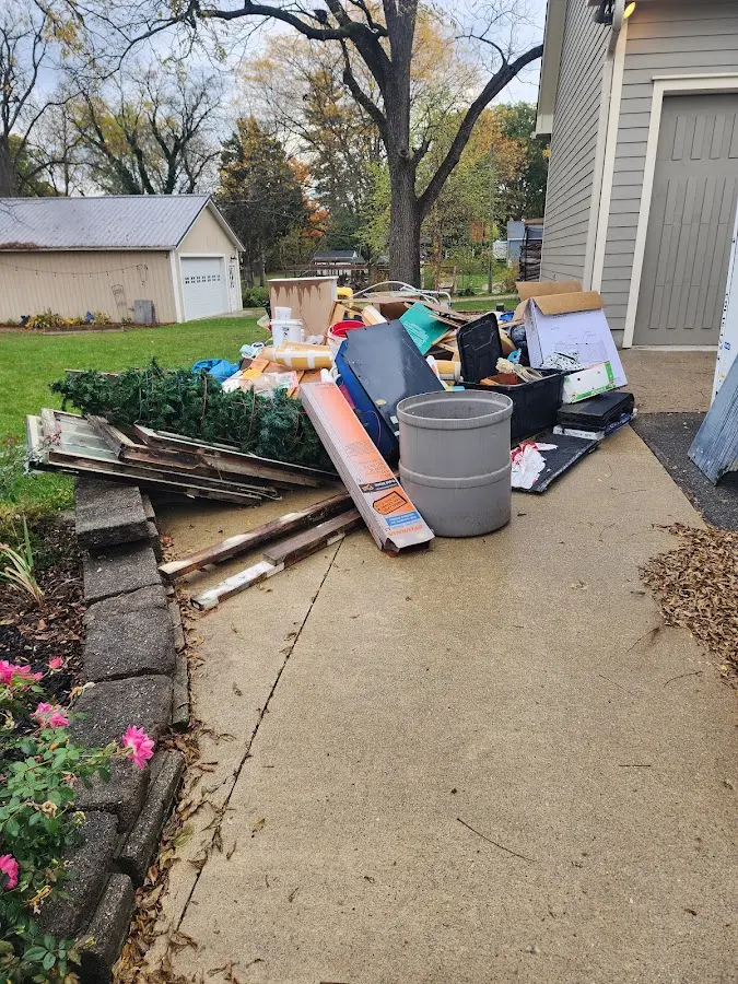 Dumpster being loaded with debris for Residential Dumpster Rental in Brunswick